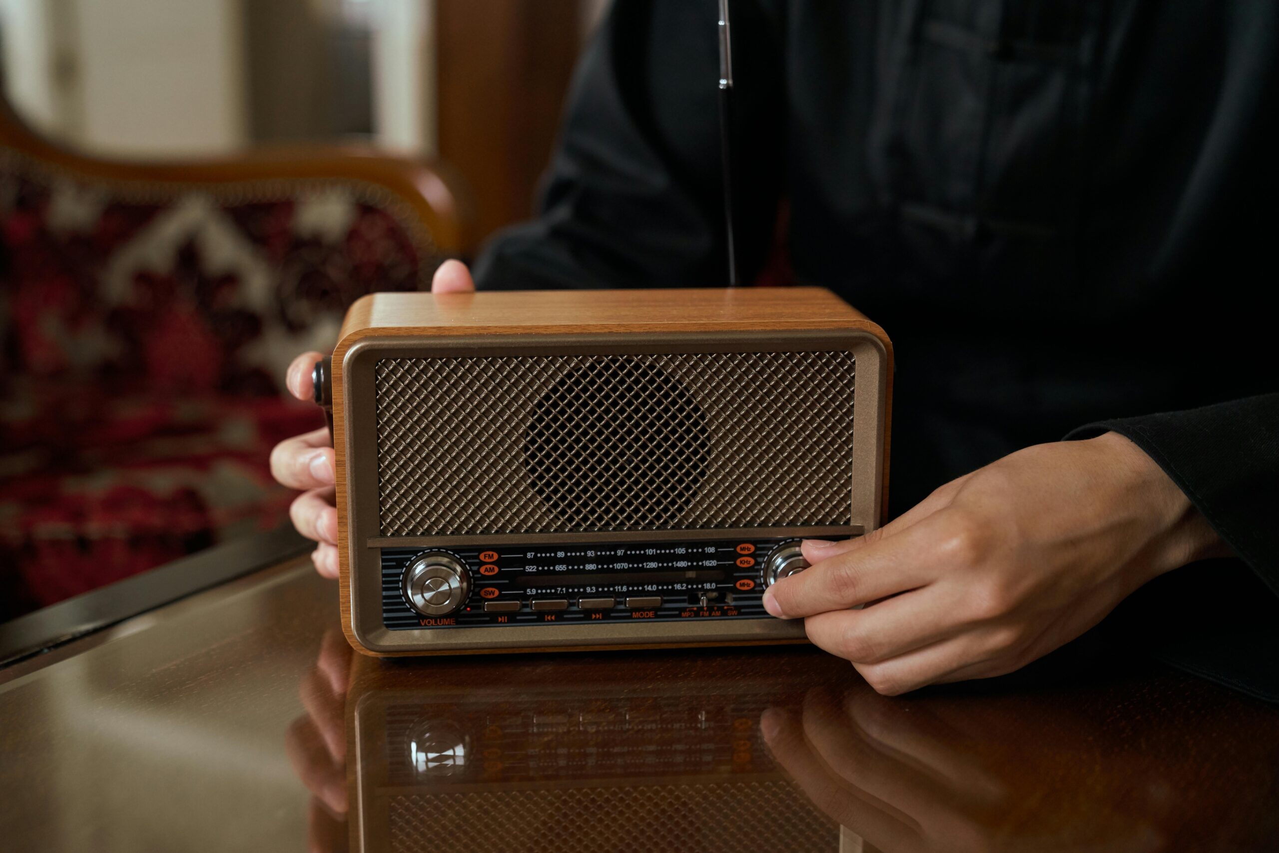 Person tuning an old fashioned radio